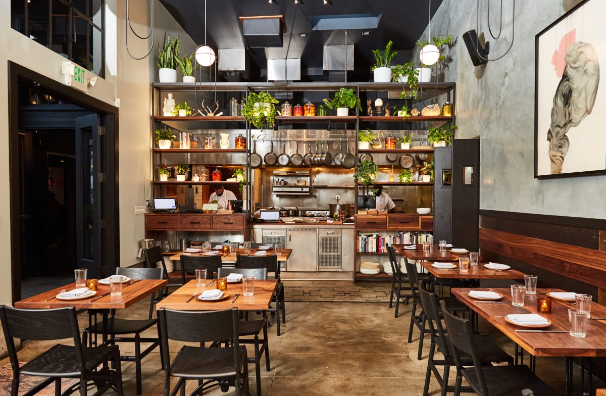 Modern restaurant patio with warm wood tones, ideal for intimate gatherings and corporate events.