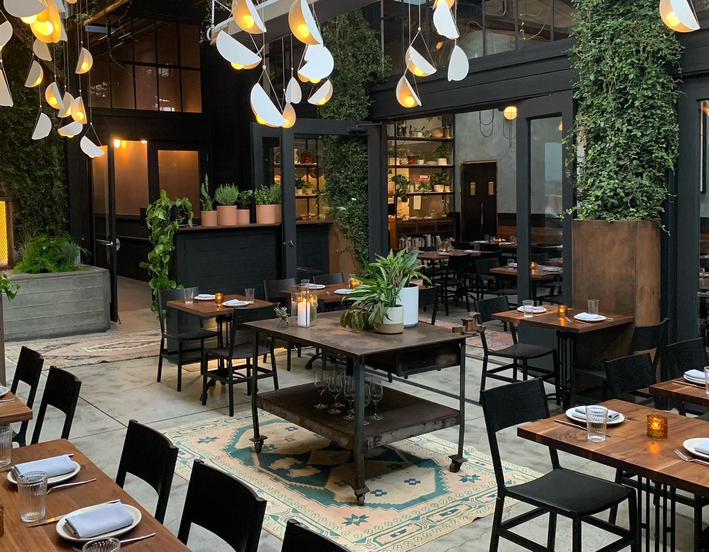 Stylish event space in Penny Roma with greenery, perfect for corporate gatherings.