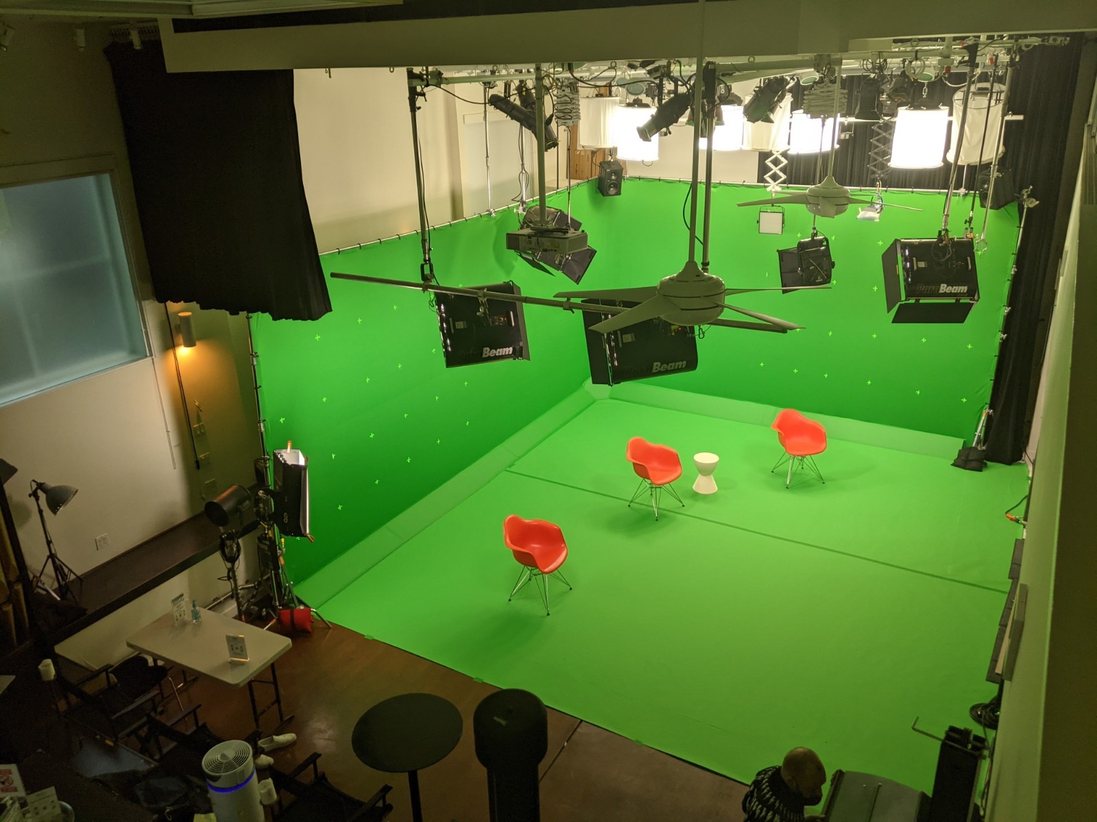 Black Limbo green screen studio for hybrid events with dynamic lighting and seating.
