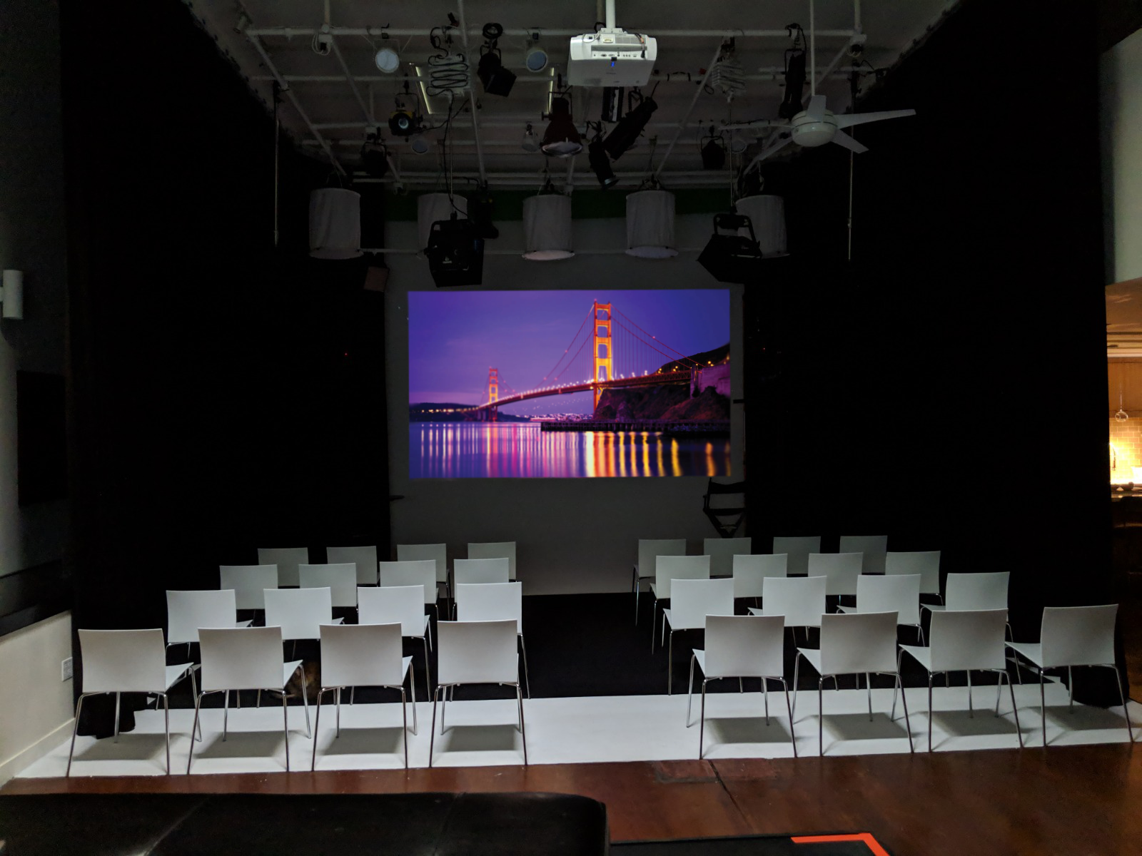 Event space in The Producer's Loft with large screen for corporate presentations.