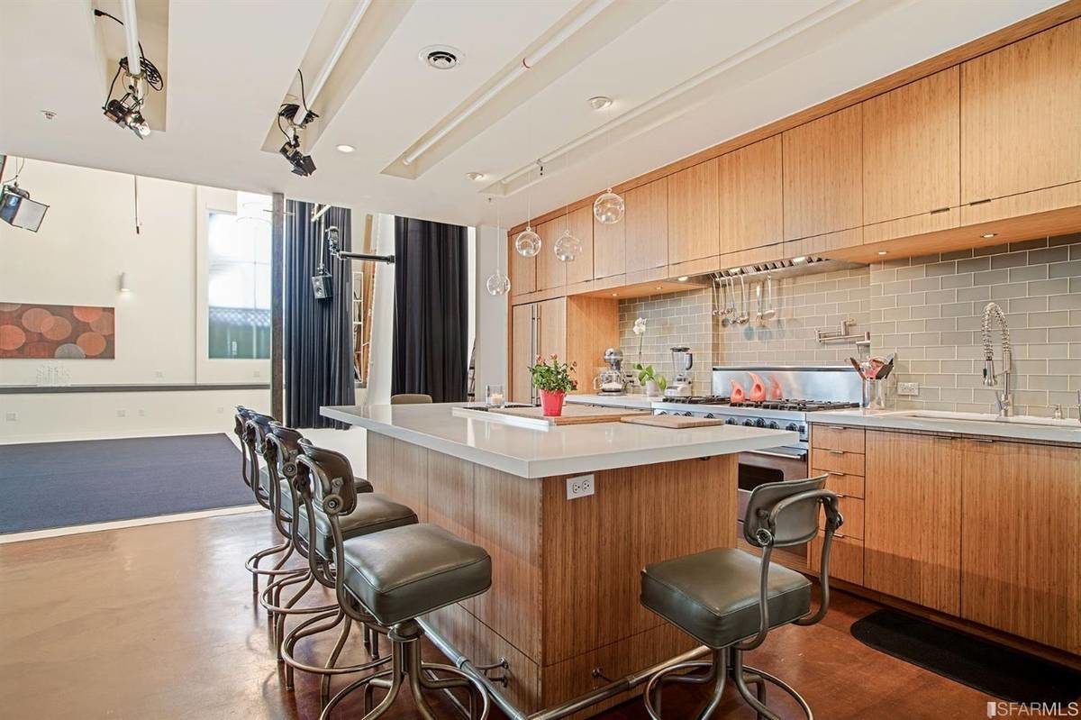 Modern kitchen with spacious island in The Producer's Loft for events and cooking demos.