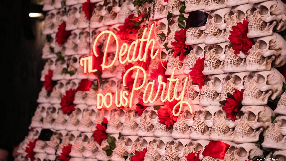 Primary bar area with skull wall and flowers, ideal for Halloween or Día de los Muertos events.