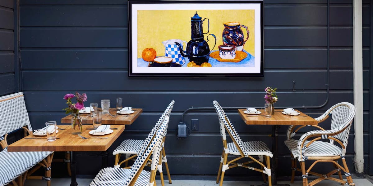 Communal table in Marlowe, warm decor for intimate gatherings and networking events.