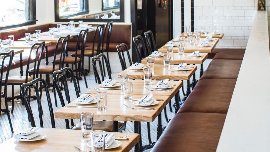 Communal table in Marlowe, modern decor for events and meetings, inviting atmosphere.