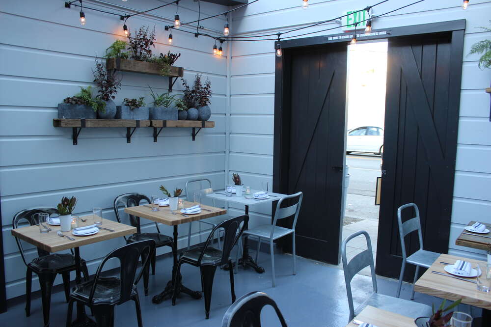 Charming patio dining space with rustic decor for intimate events and meetings.