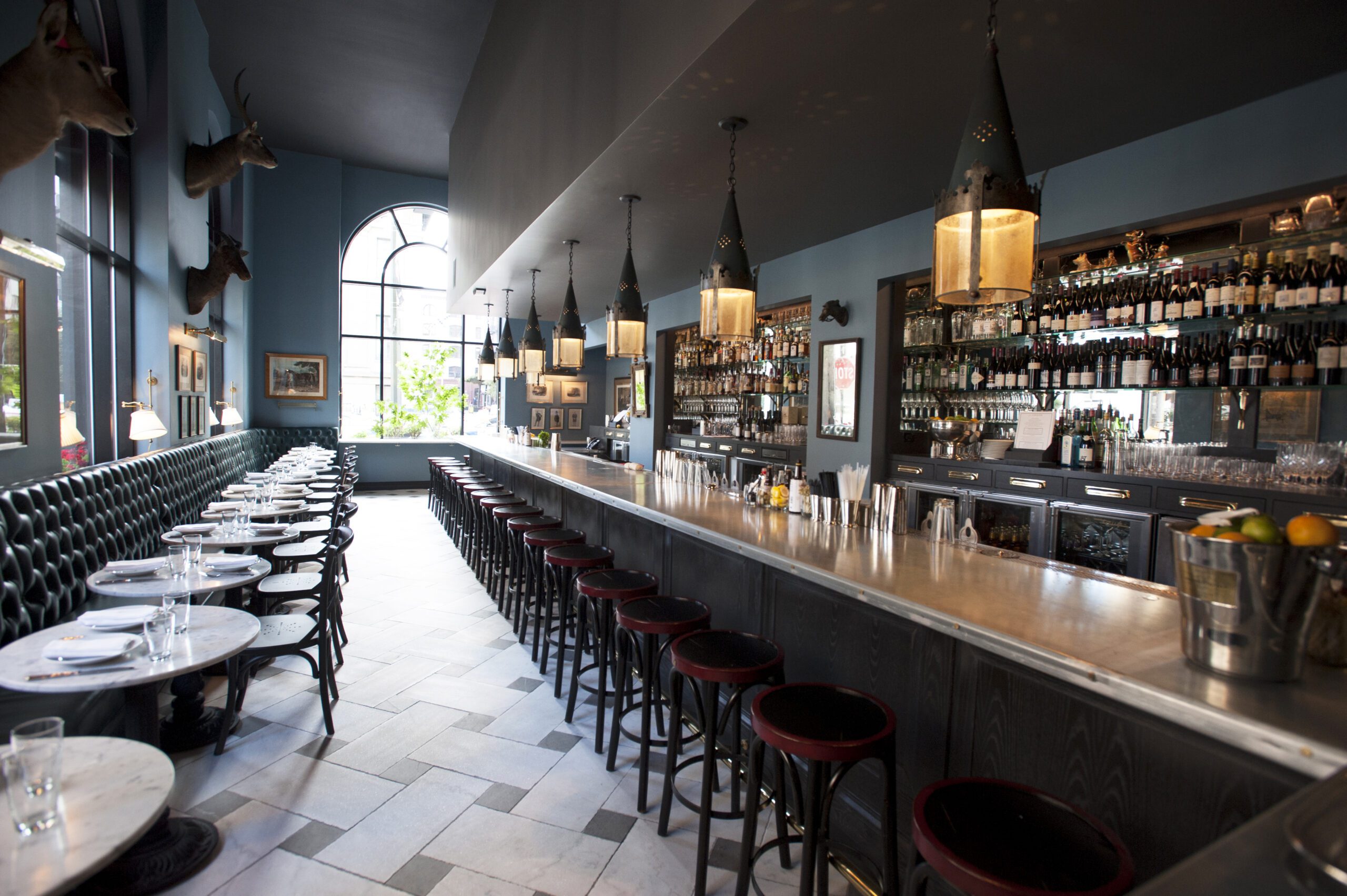 Stylish bar area with marble tables at The Rail Car, perfect for networking events.