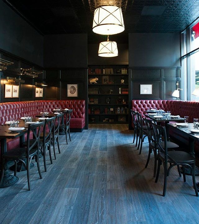 Stylish restaurant with plush red booths, ideal for intimate meetings and events.