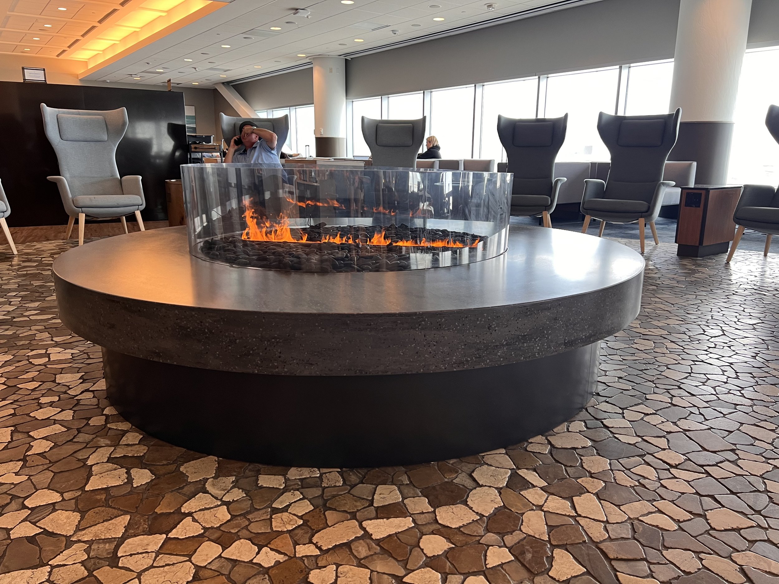 Alaska Airlines Club Level lounge with circular fire pit, ideal for networking events.