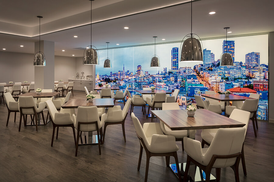 Modern event space at Hotel VIA with sleek furniture and cityscape backdrop.