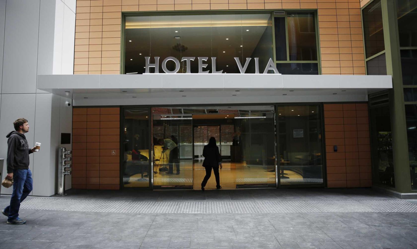 Modern Hotel VIA entrance, sleek design for meetings and events, urban venue.