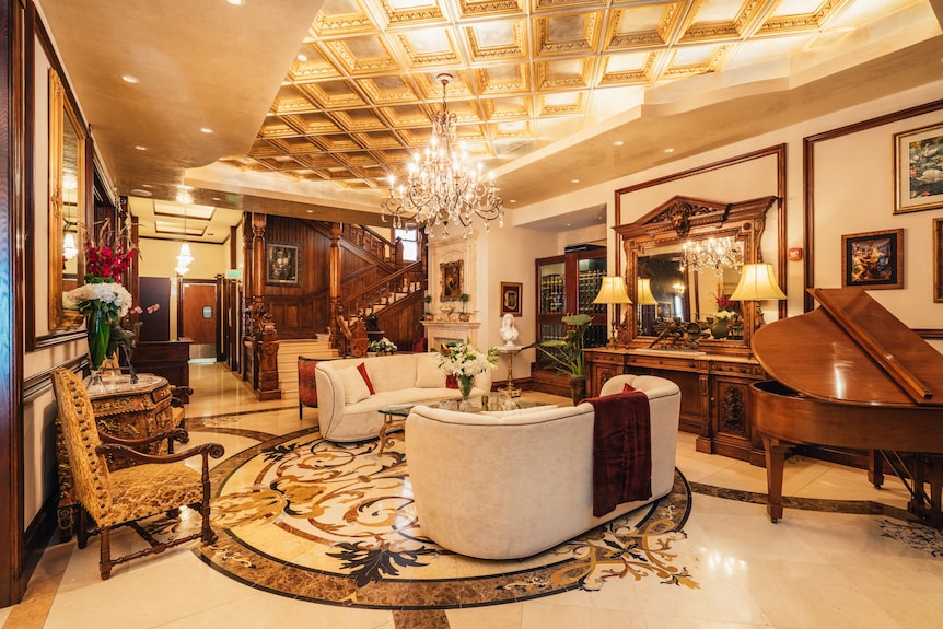 Elegant banquet hall with grand chandelier, ideal for intimate gatherings and receptions.