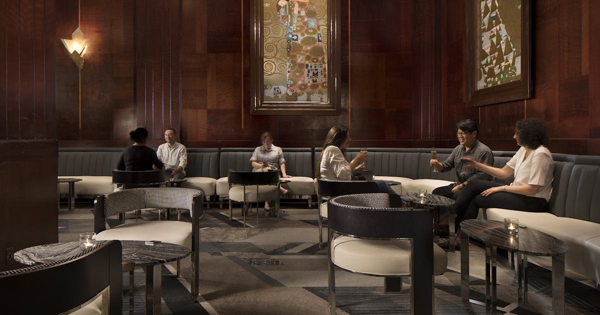 Redwood Room lounge with warm wood paneling, ideal for networking events and meetings.