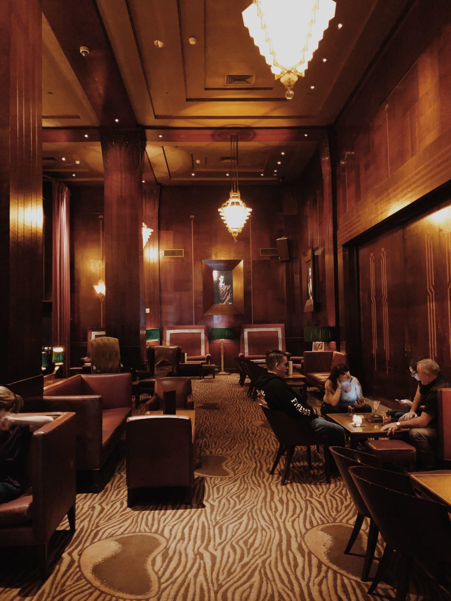 Redwood Room lounge with warm wood paneling, ideal for networking events and meetings.