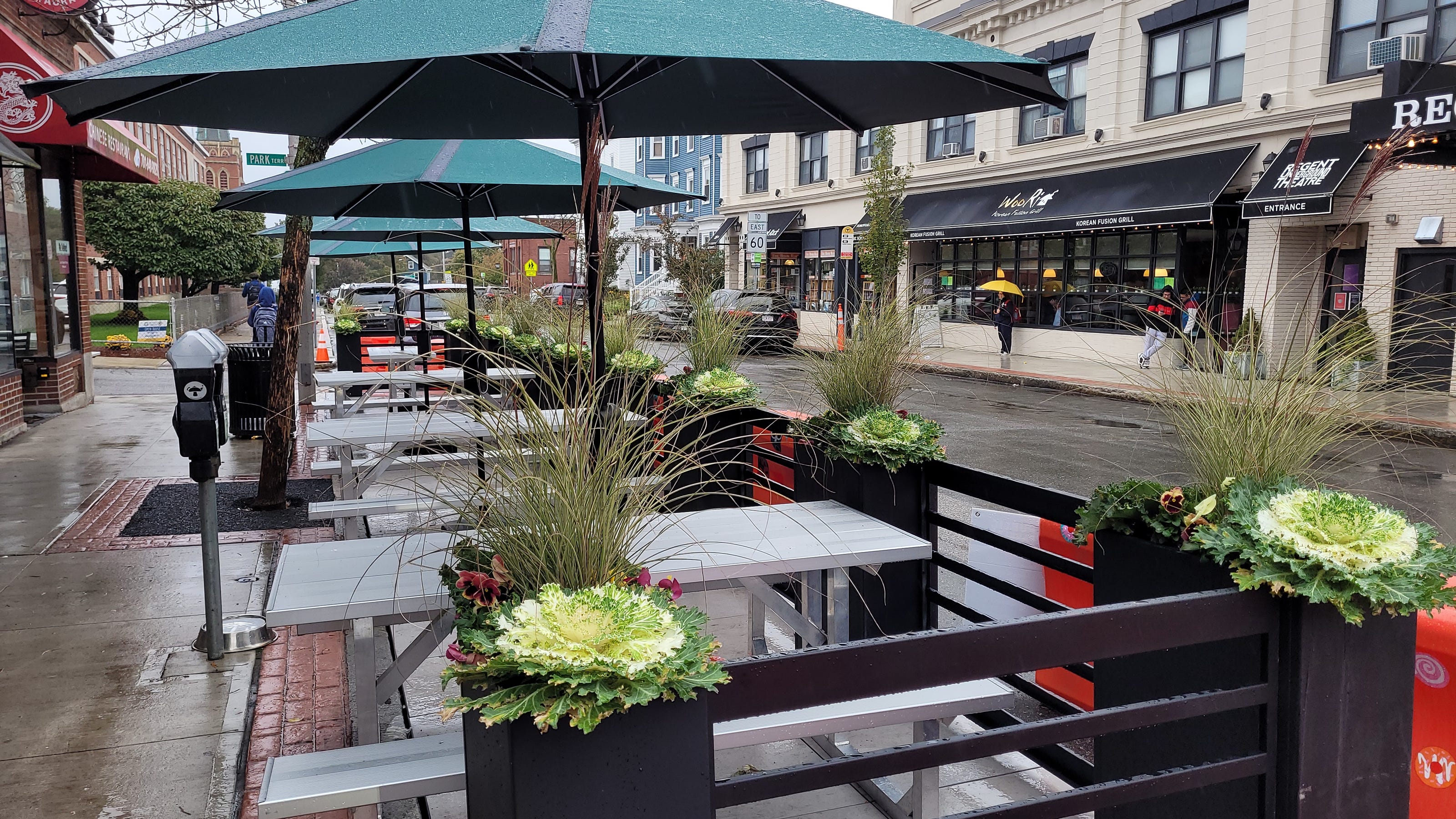 Outdoor parklet at Marzano Restaurant with tables under umbrellas for events.
