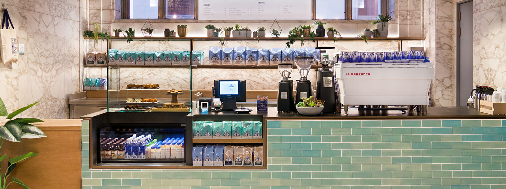"Stylish coffee station at Bluestone Lane Roastery for events and networking."