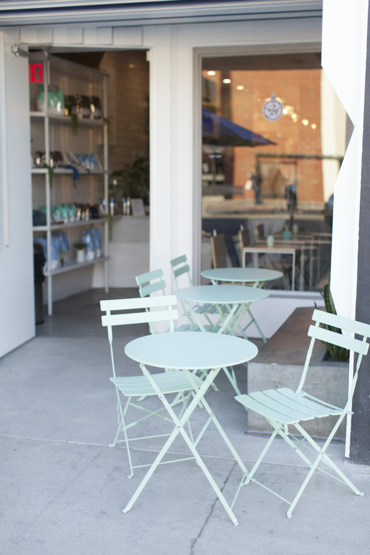 Outdoor seating area in Studio City, featuring pastel tables for casual meetings and networking.