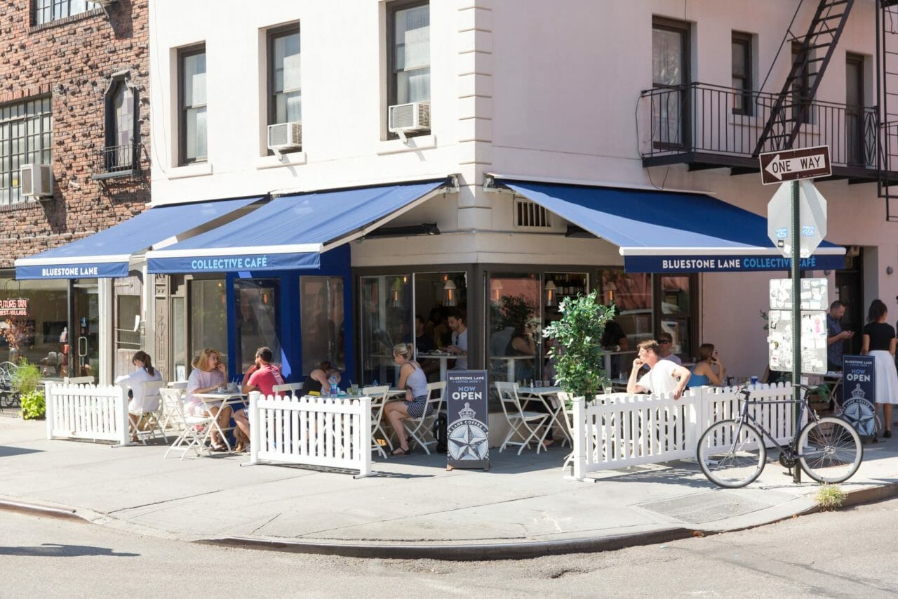 Outdoor café in Santa Monica with blue awnings, perfect for casual meetings and networking.