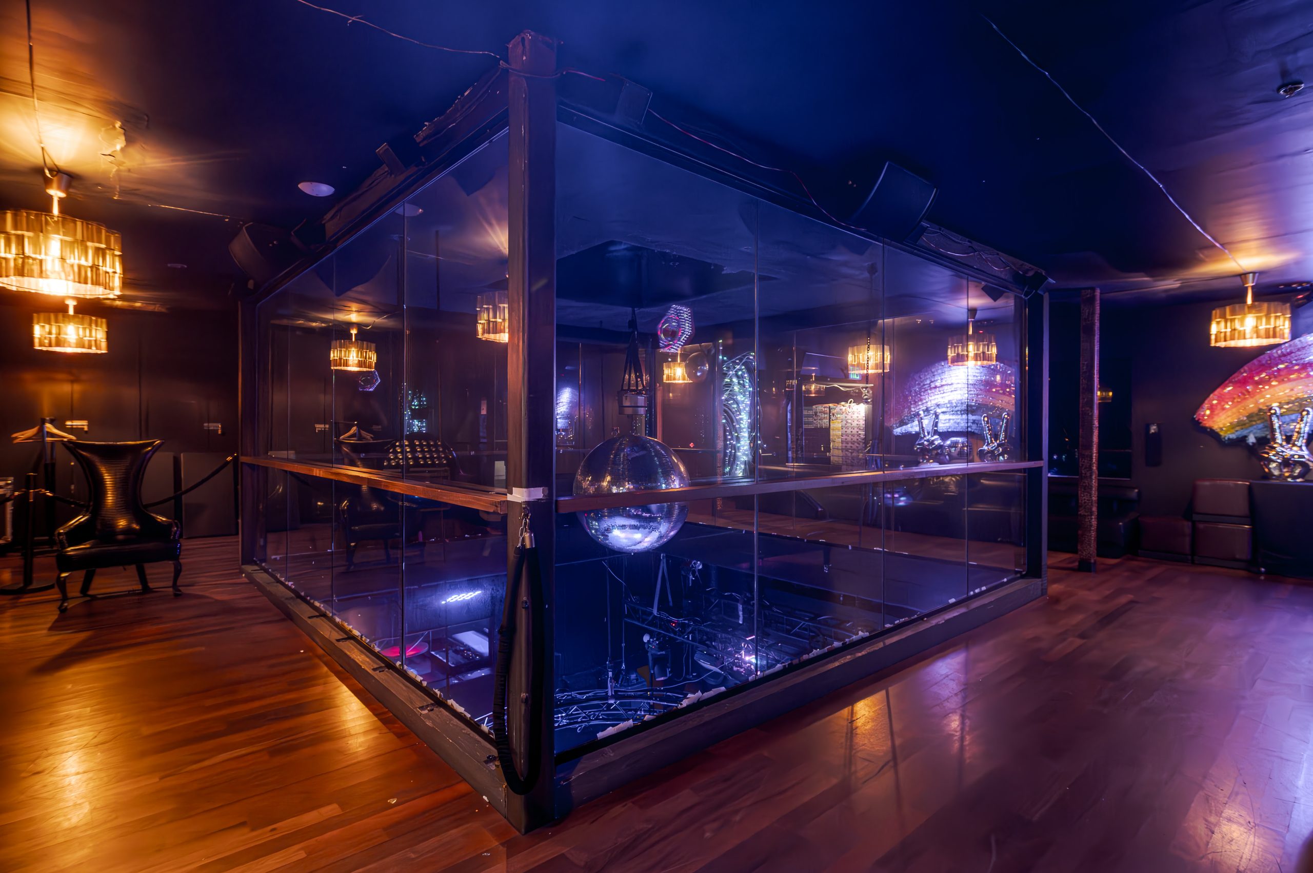 Stylish event space at Lin Lounge with glass stage, perfect for upscale gatherings.