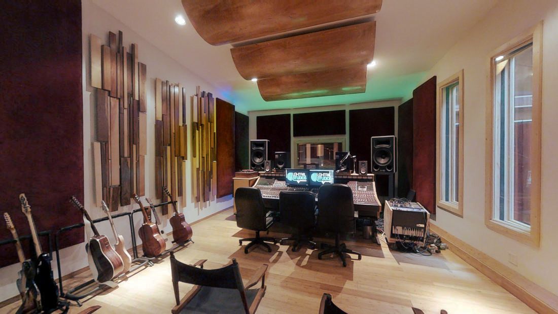 Modern recording studio control room with acoustic panels for music production events.