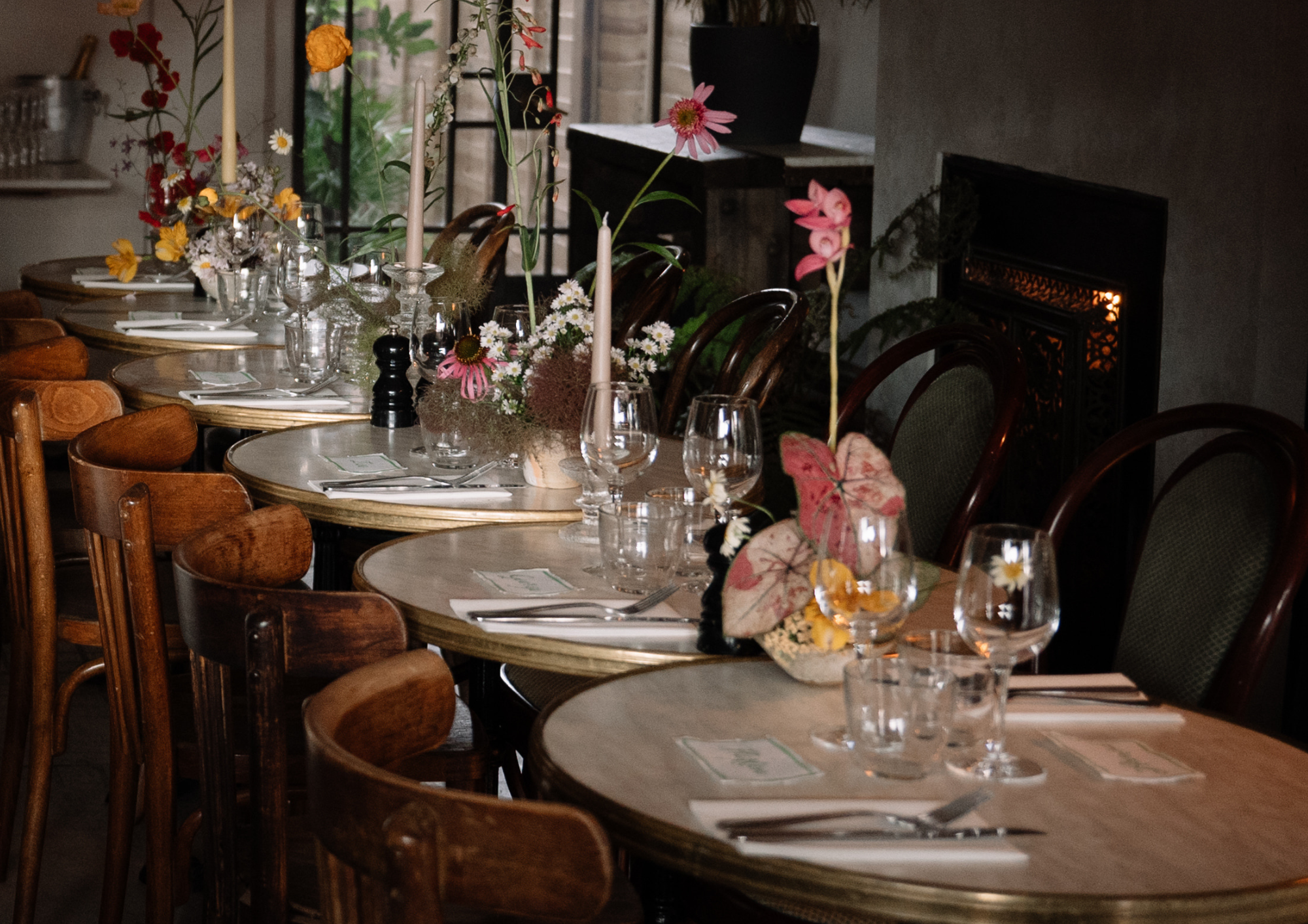 Private dining room with elegant setup, floral centerpieces for weddings and events.