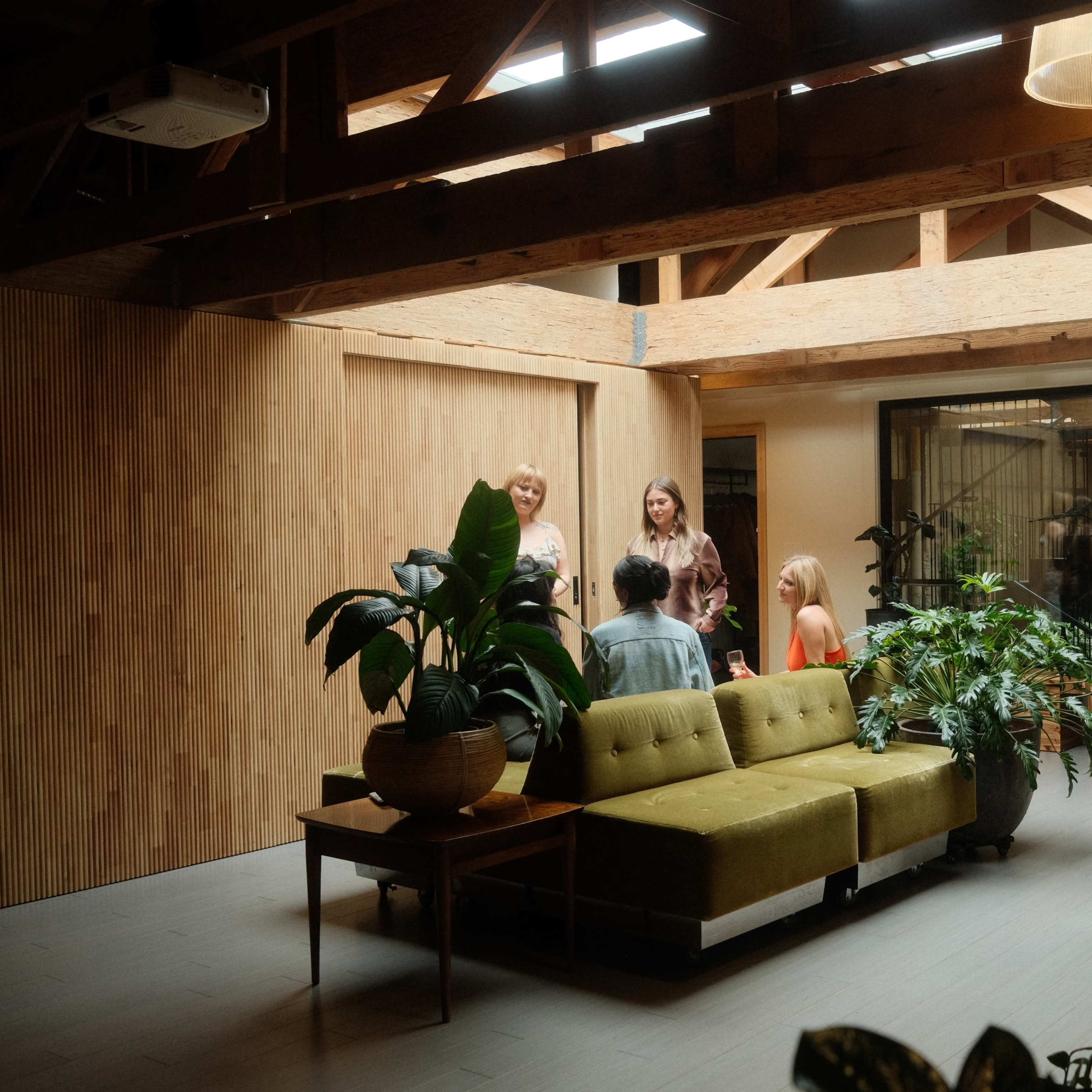 Modern meeting space with natural light and greenery, ideal for networking events and workshops.