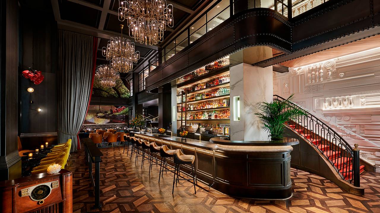 Sophisticated events venue with elegant bar and chandeliers for upscale gatherings.