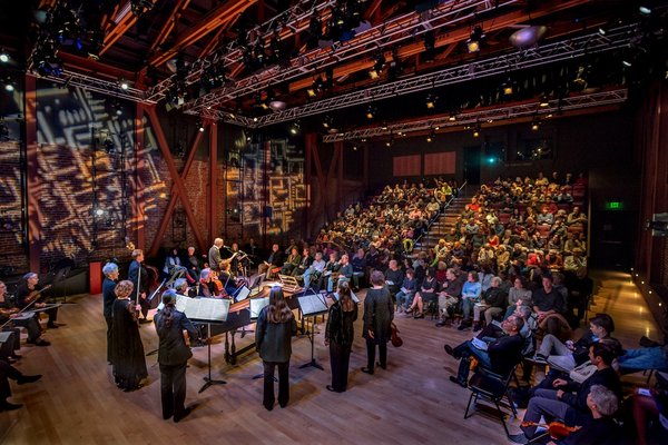 "ODC Theater lobby with musicians performing, showcasing cultural events and acoustics."