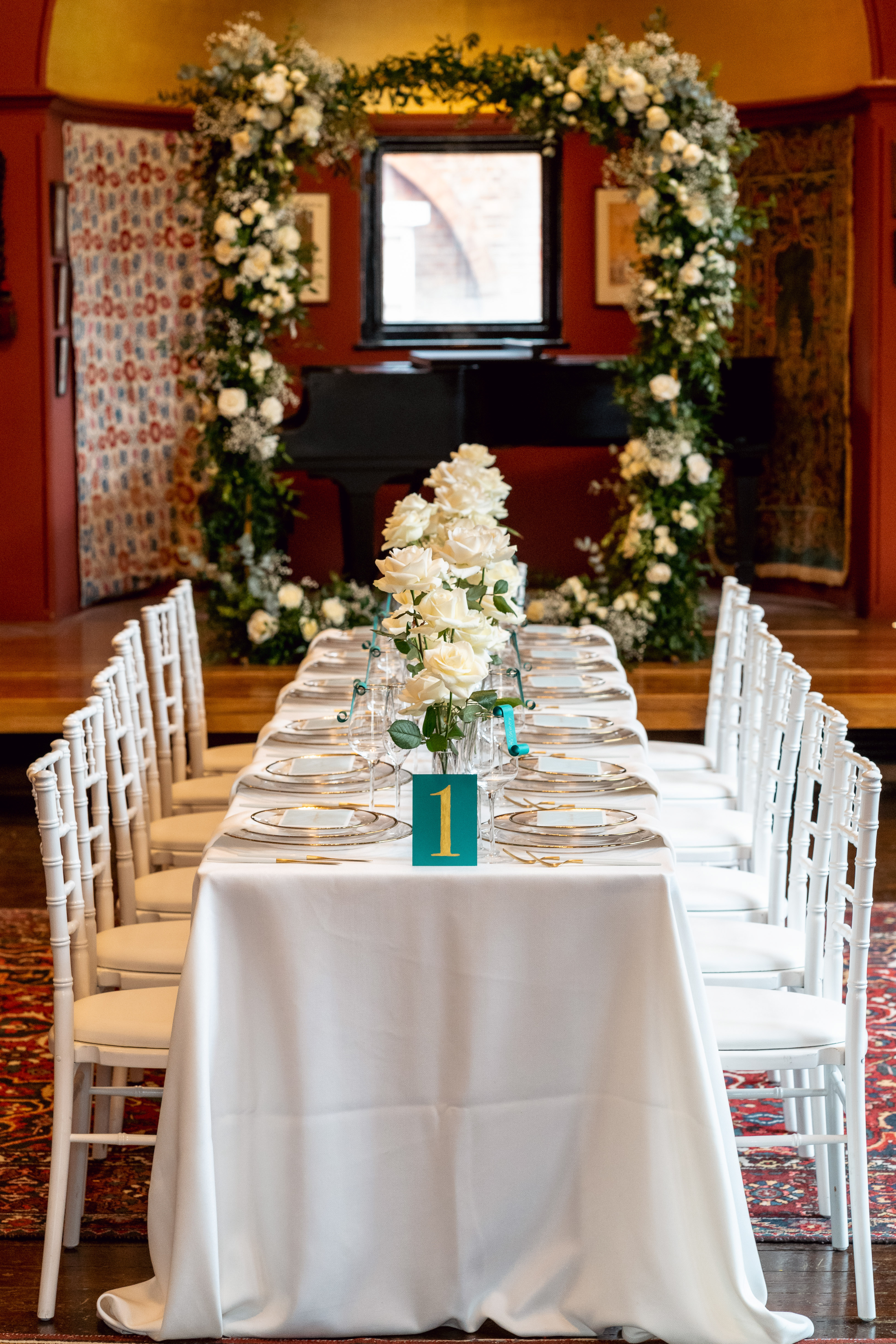 Elegant banquet table with floral centerpieces in Leighton House for upscale events.