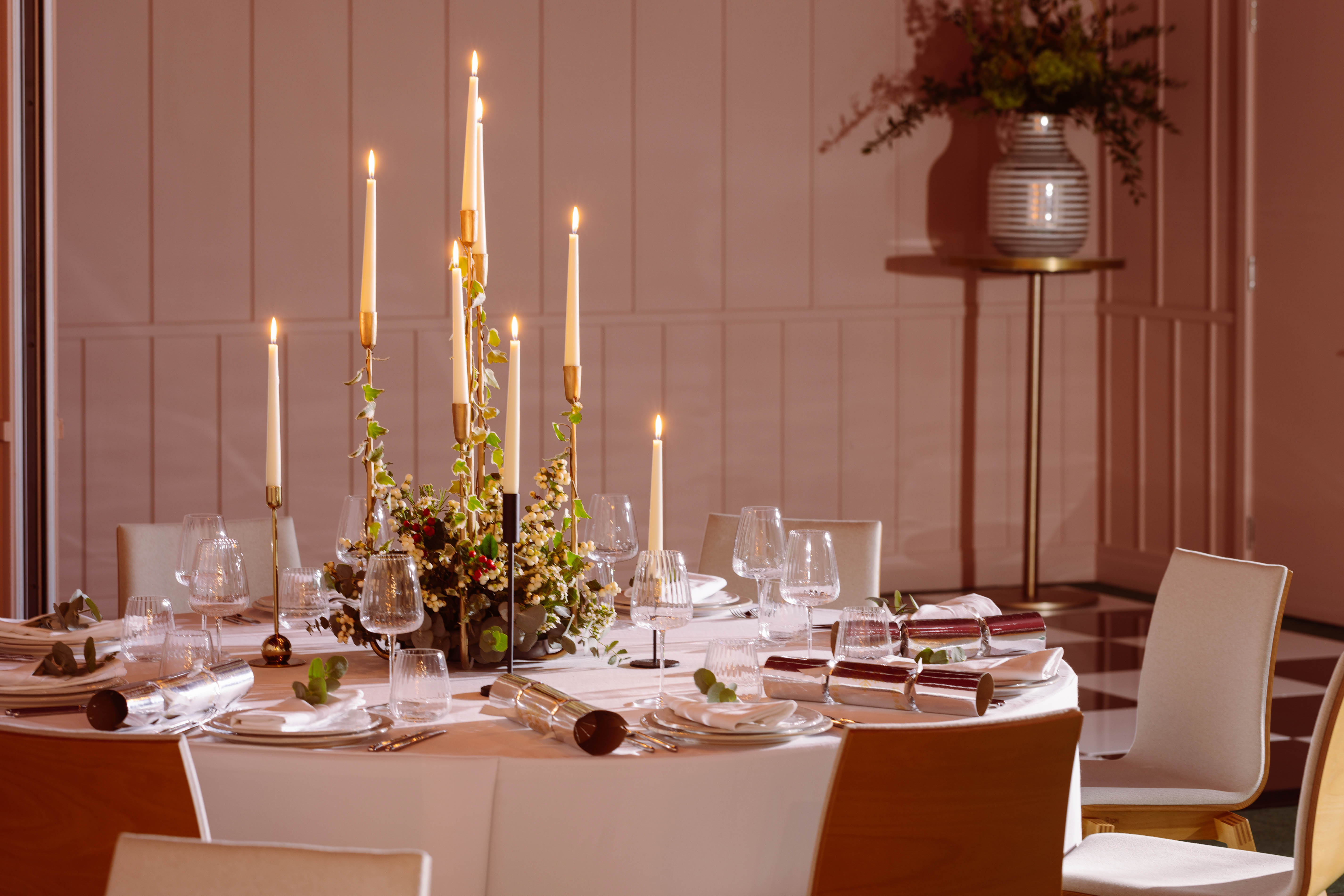Elegant dining table with candles in Creative Room 1, perfect for formal events and galas.