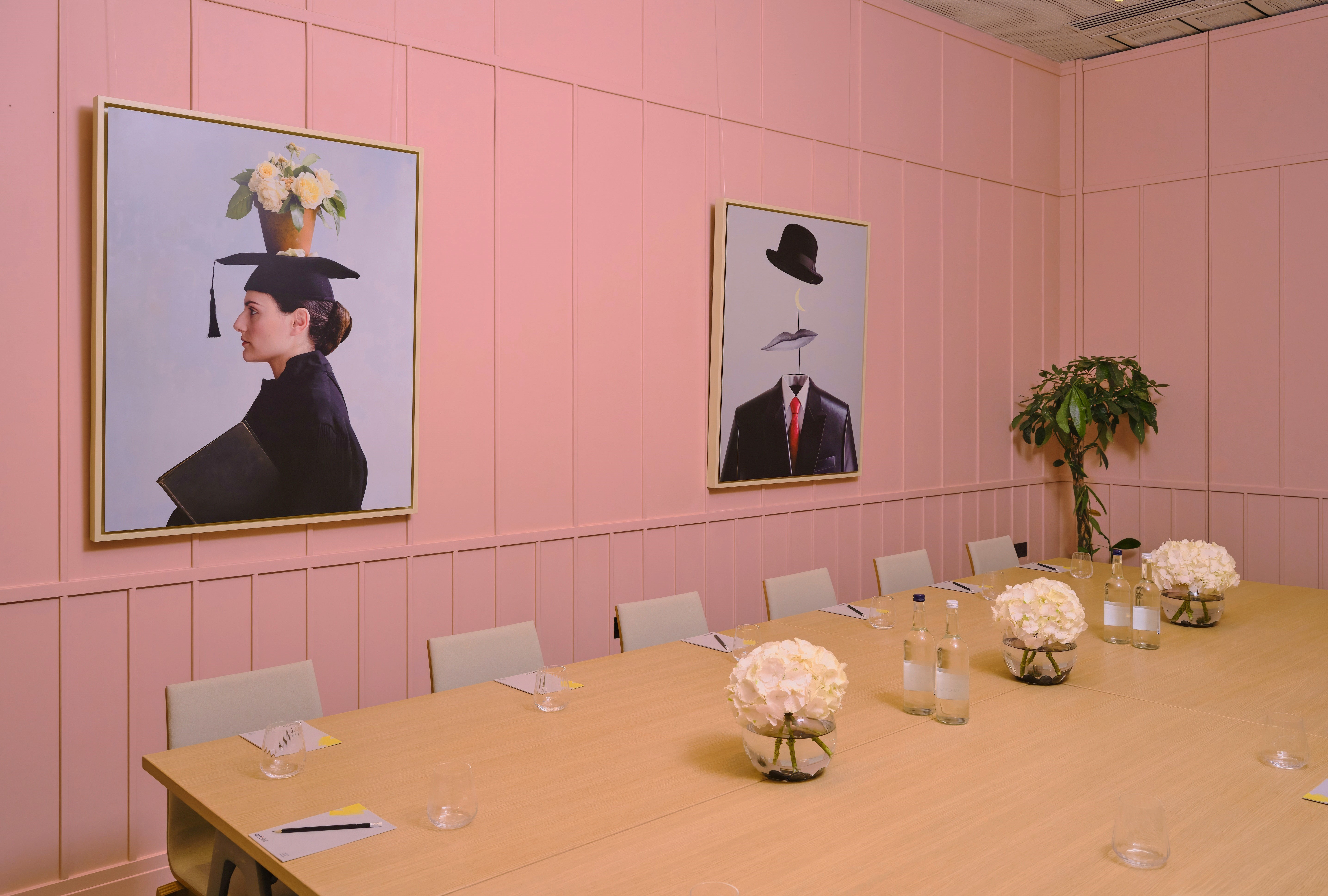 Stylish meeting room with pink walls for creative brainstorming and corporate events.
