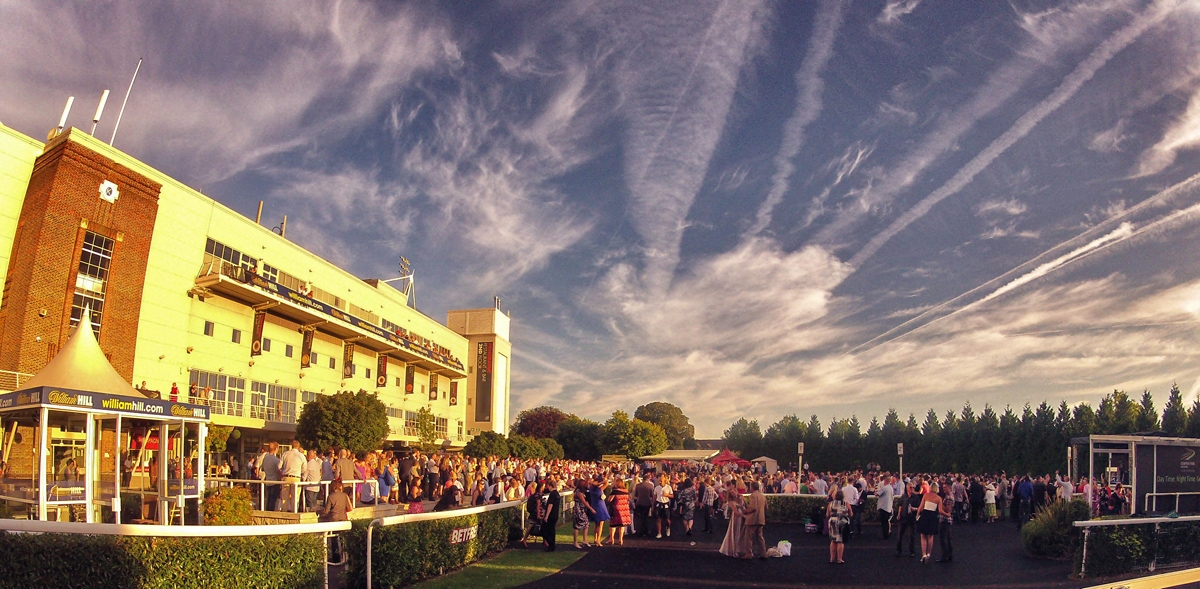 Exhibition Hall at Kempton Park Racecourse, vibrant outdoor corporate event with large crowd.