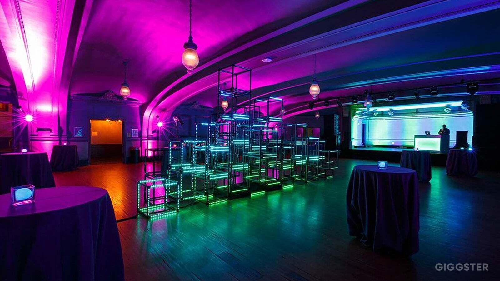 Vibrant event space in Social Hall SF with dynamic purple and green lighting for gatherings.