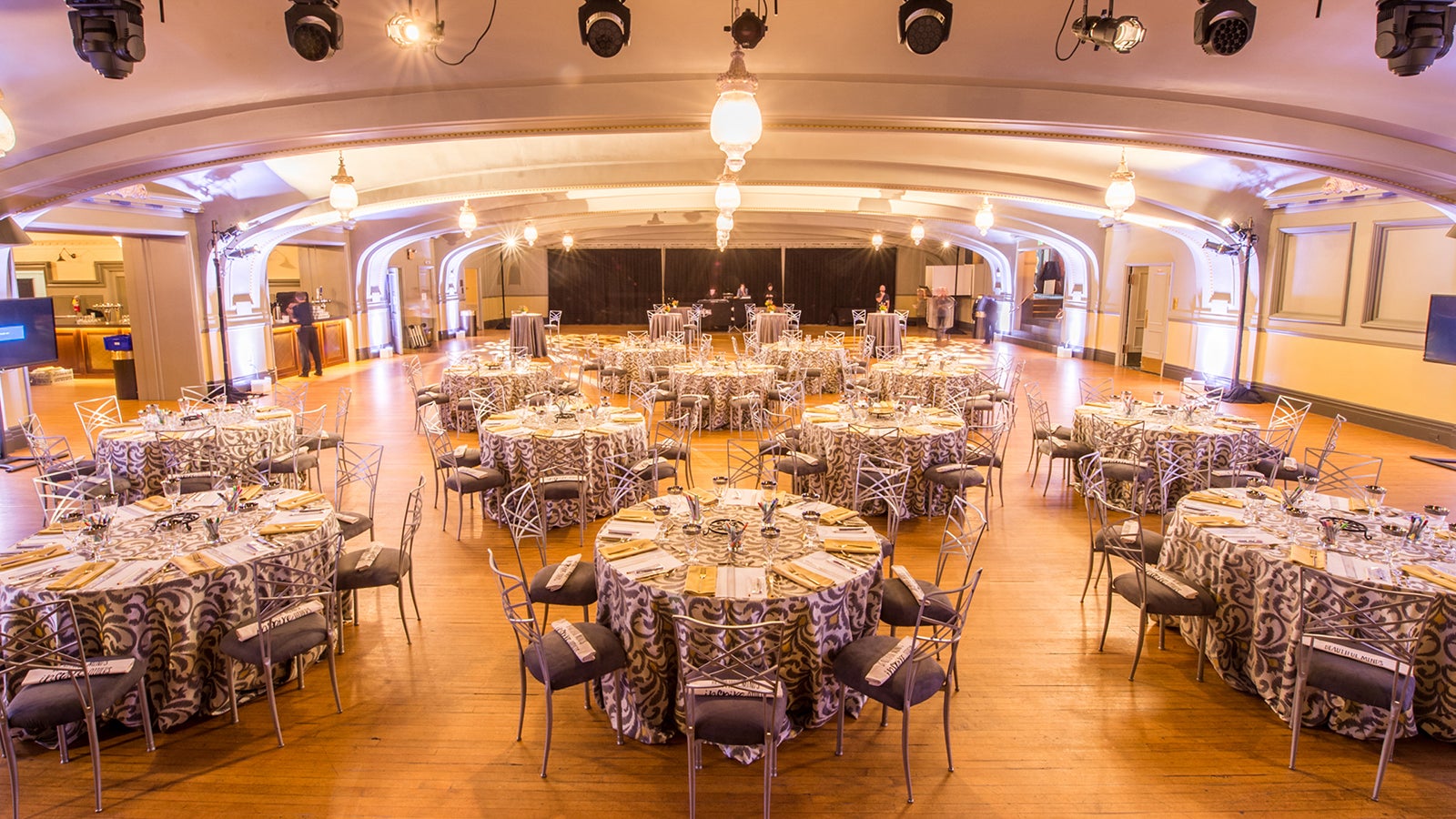 Elegant event space with round tables, perfect for corporate events and celebrations.