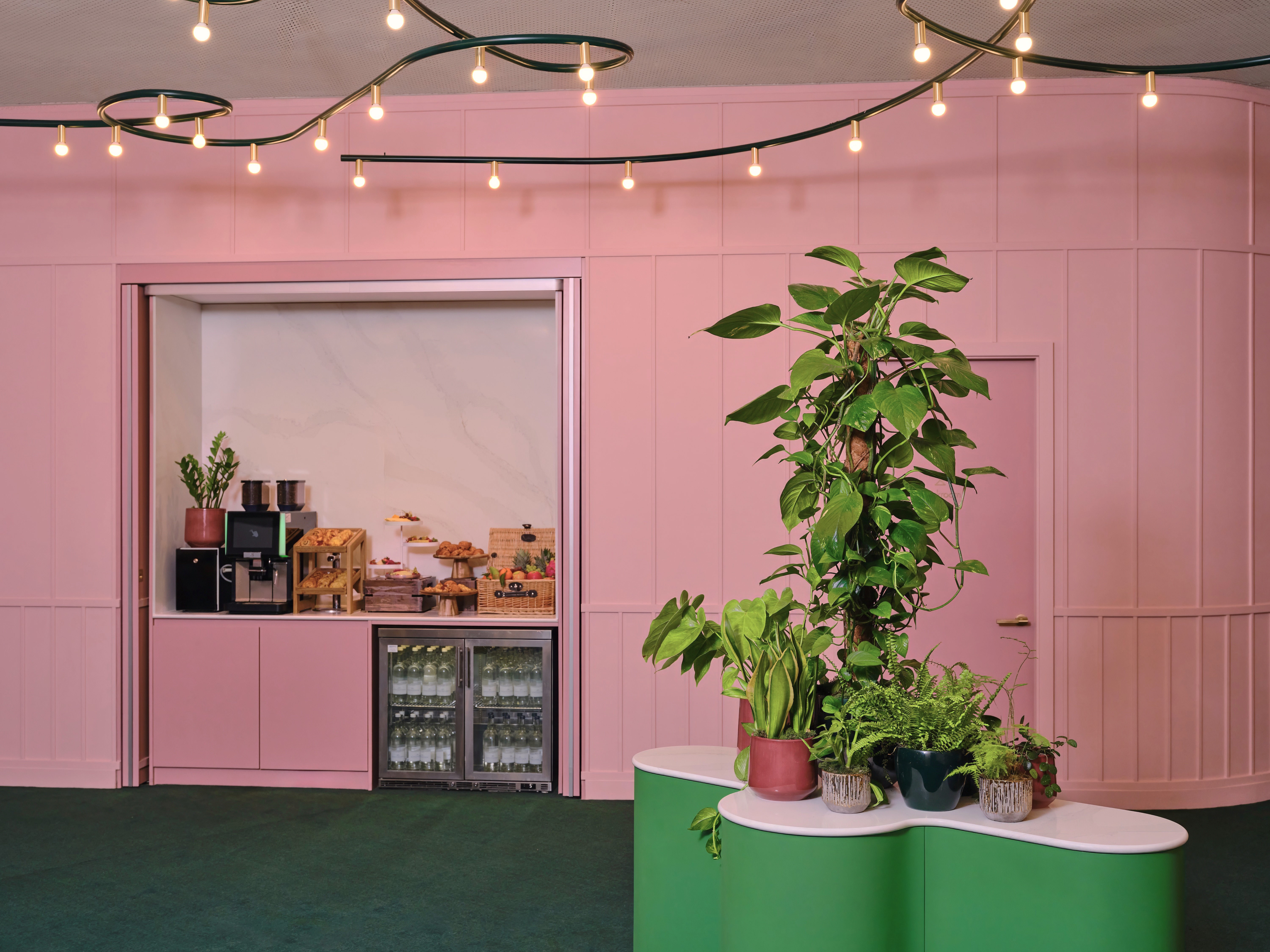 Vibrant event space with pink walls and greenery at art'otel London Battersea Power Station.
