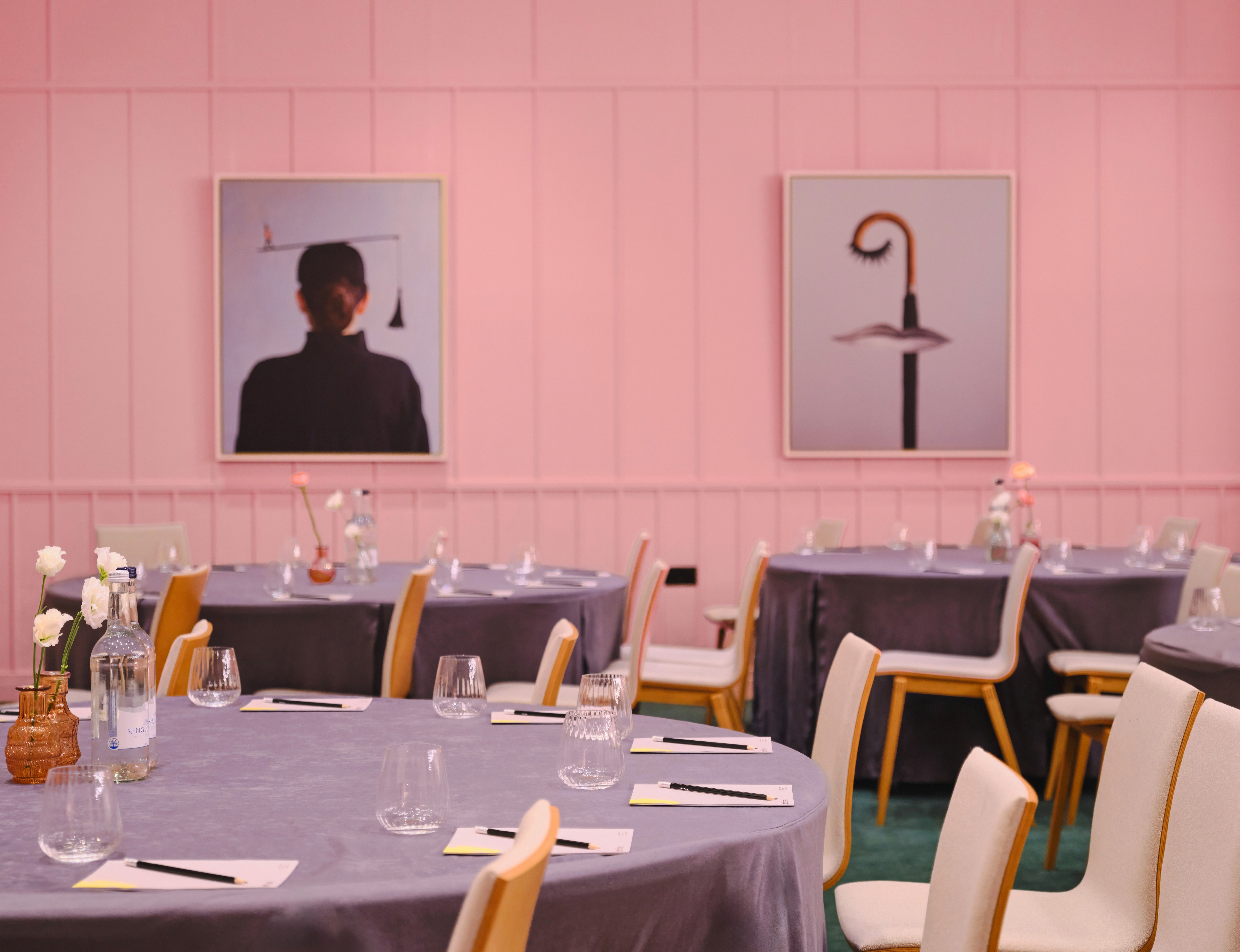 Stylish event space with round tables and pink walls at art'otel London Battersea.