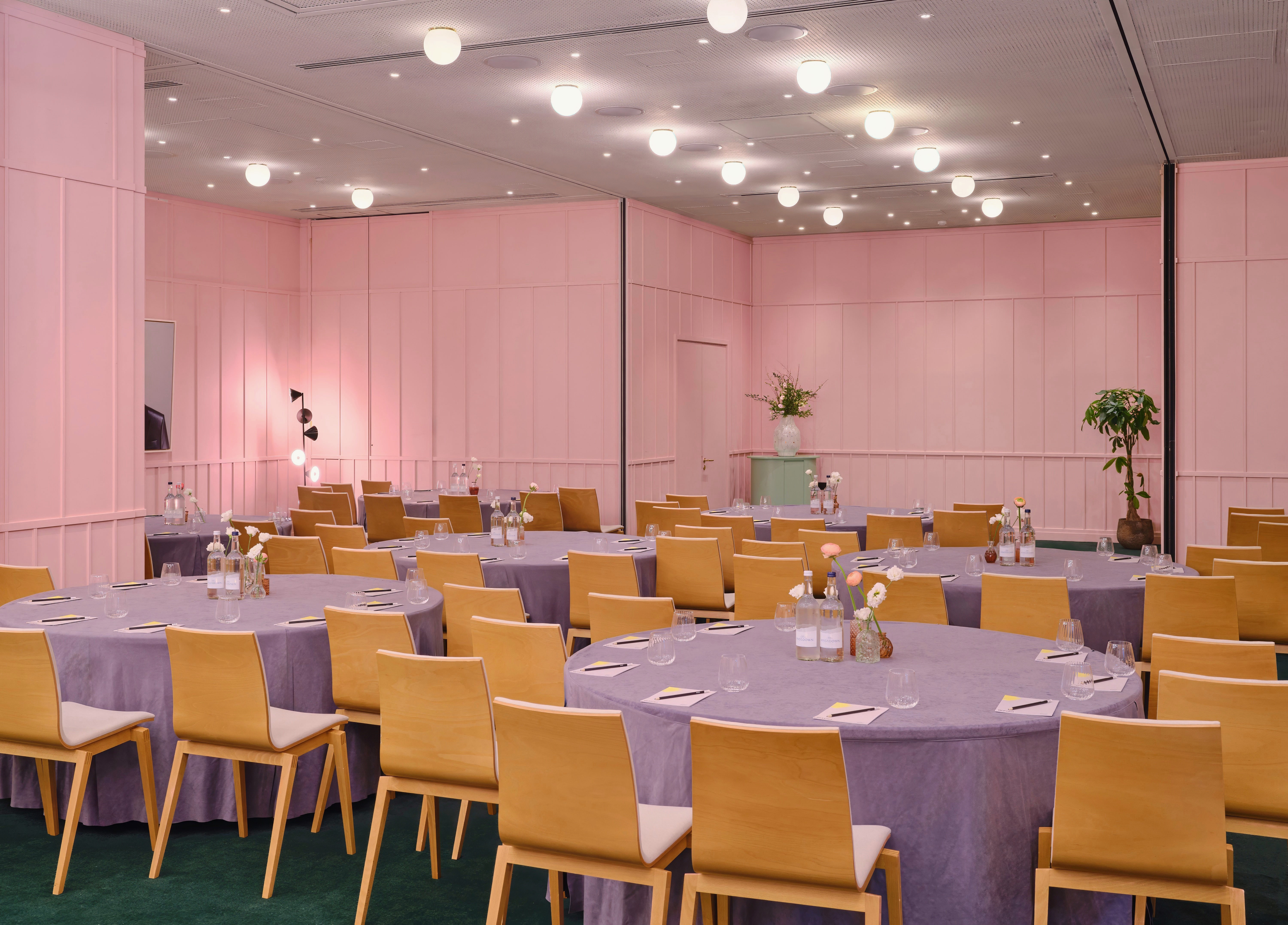 Elegant event space with purple tablecloths at art'otel London Battersea Power Station.