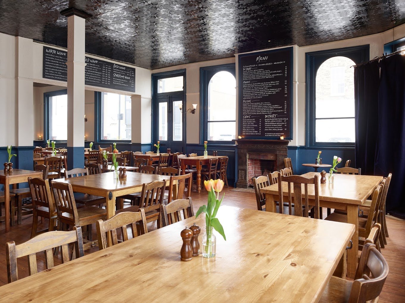 Spacious Lansdowne Pub venue with wooden tables, ideal for meetings and events.