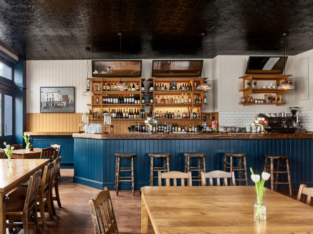 Cozy Lansdowne Pub bar with warm wood tones, ideal for networking events and gatherings.
