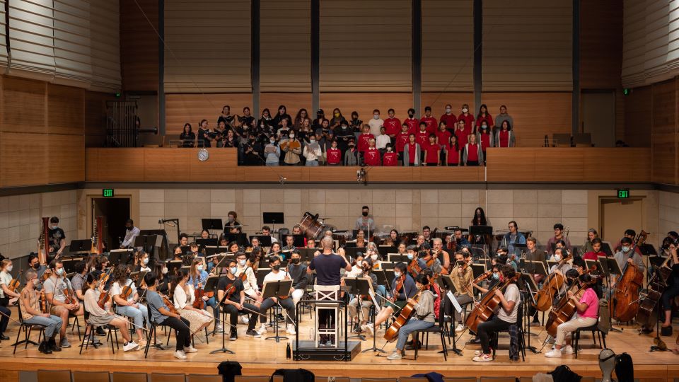 Ensemble-in-Residence rehearsing in a concert hall for music events and performances.
