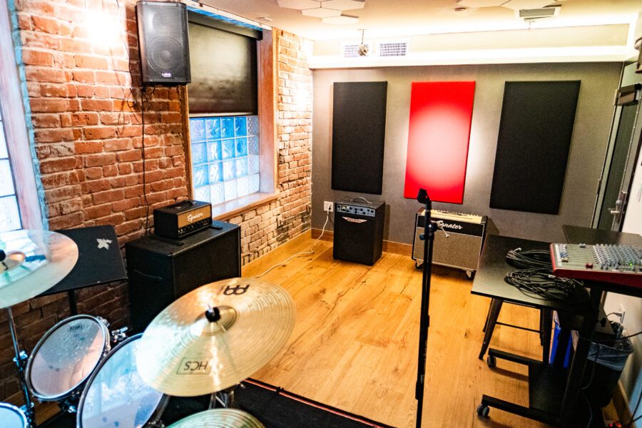 Versatile rehearsal studio with exposed brick for music events and creative workshops.