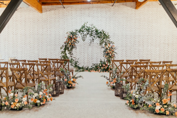 Elegant cocktail room with floral arch, perfect for intimate weddings and events.