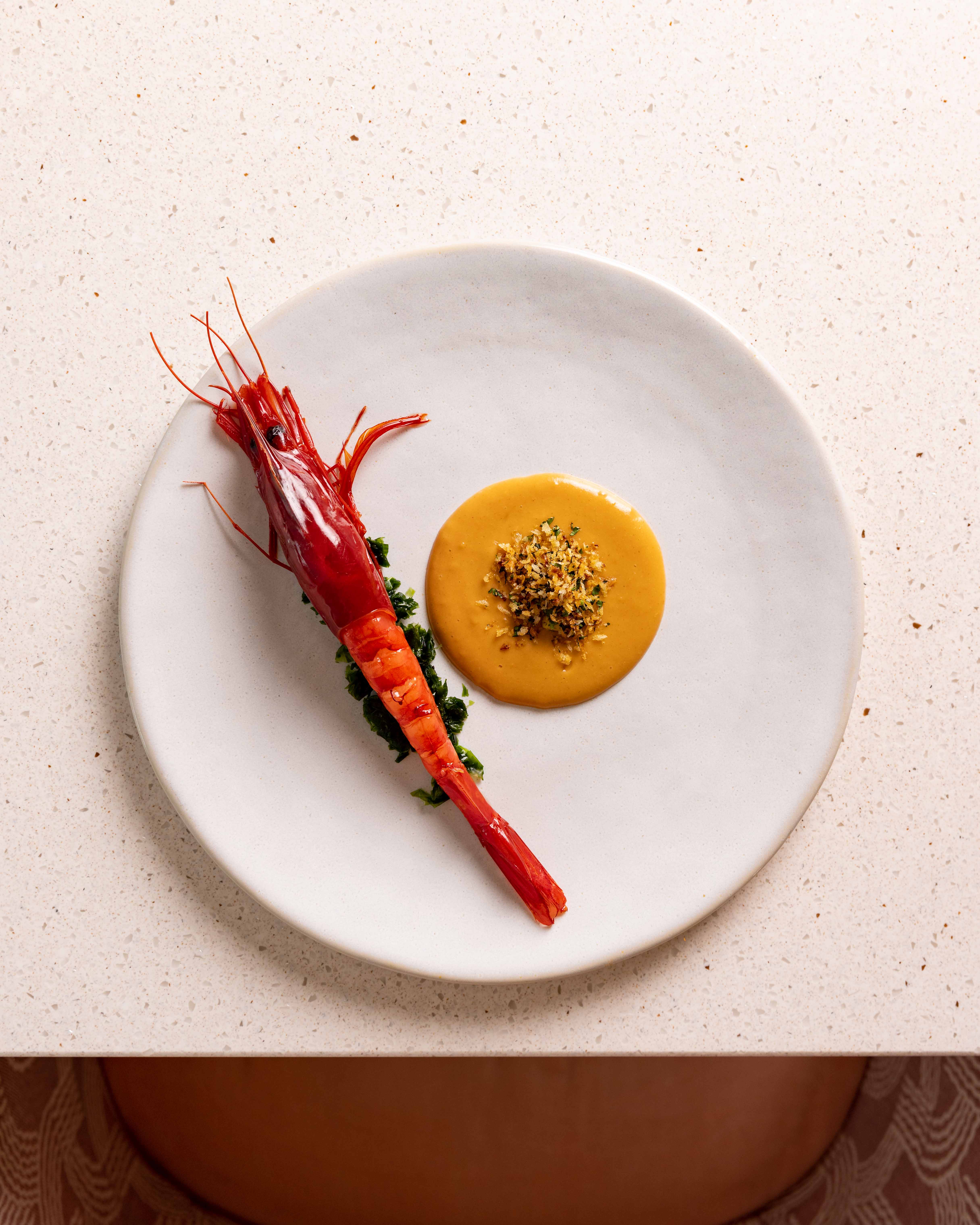Vibrant red prawn dish at JOIA Restaurant, perfect for events and culinary experiences.
