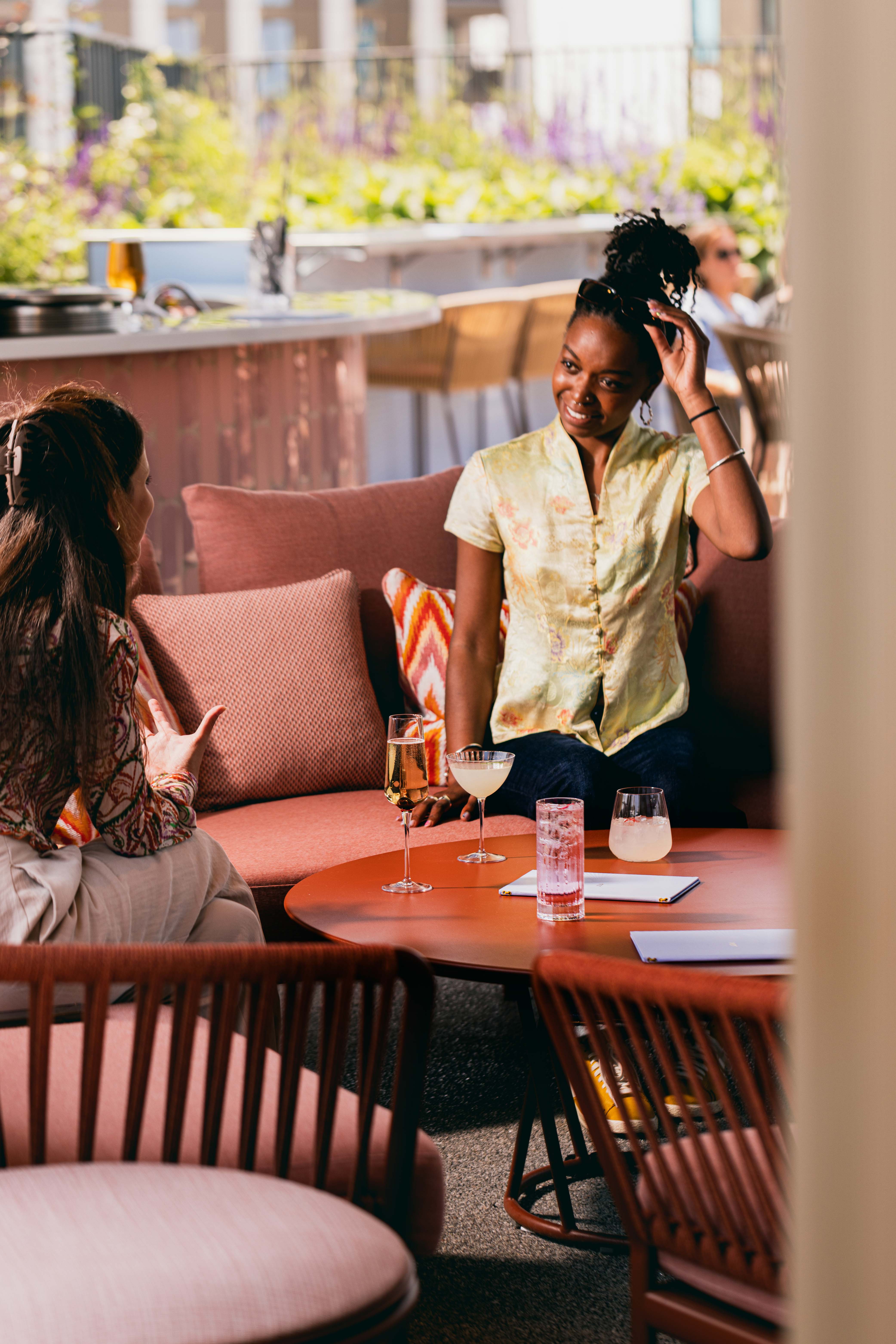 "JOIA Rooftop at art'otel London, vibrant outdoor networking space with greenery."