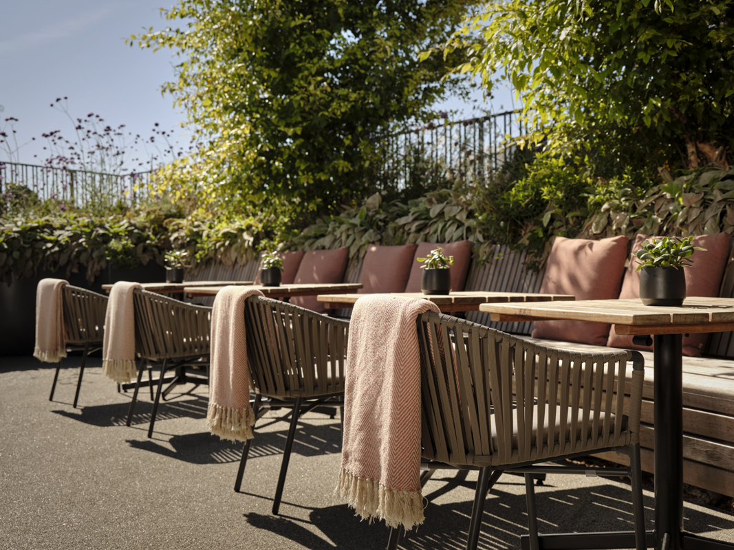 Stylish outdoor seating at JOIA Rooftop, ideal for networking events in London.
