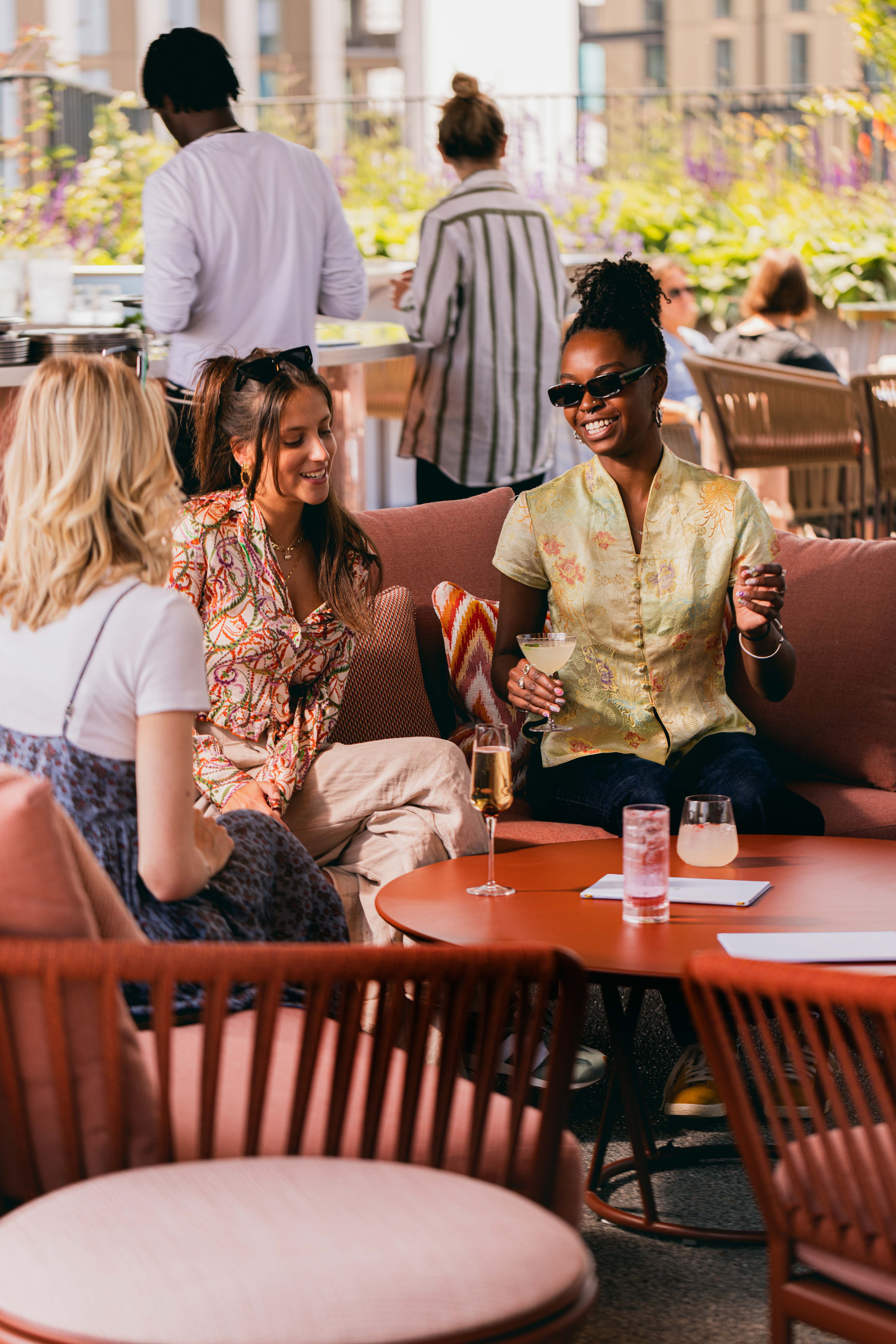 Vibrant networking event at JOIA Rooftop, art'otel London, with stylish decor and drinks.