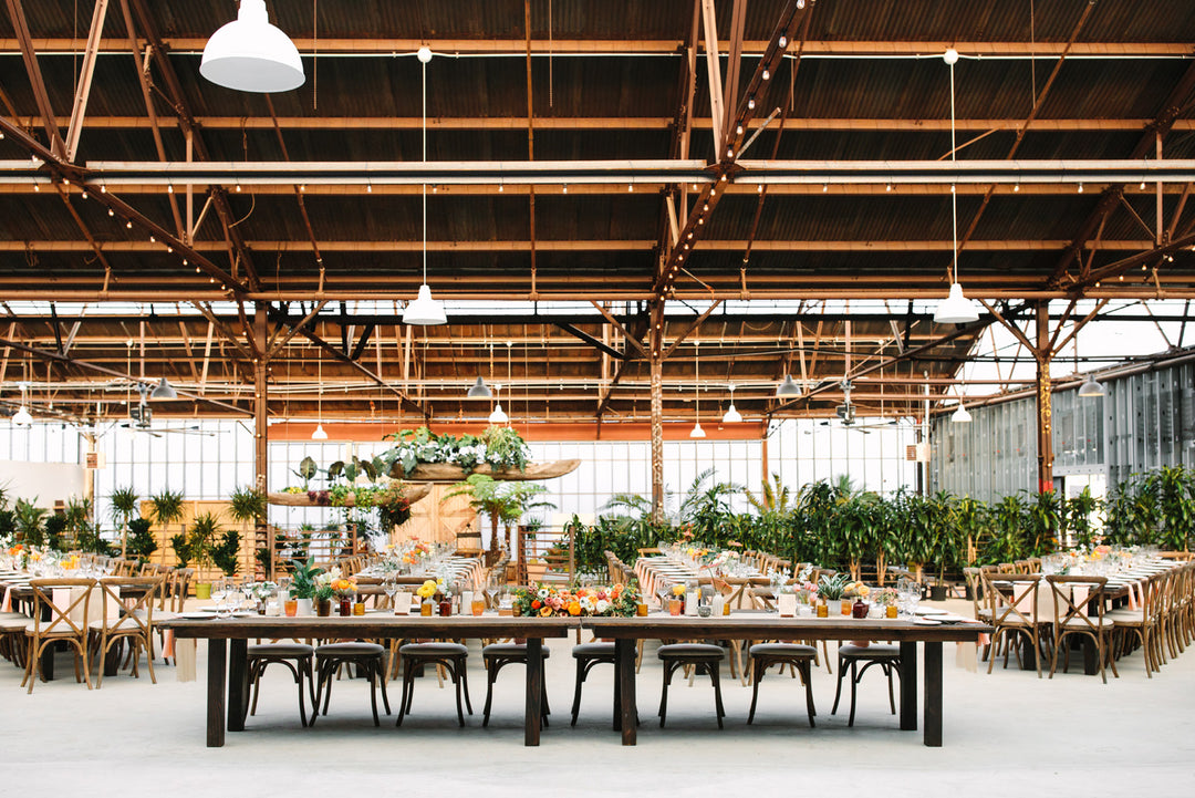 Spacious event space with communal table, ideal for weddings and networking events.