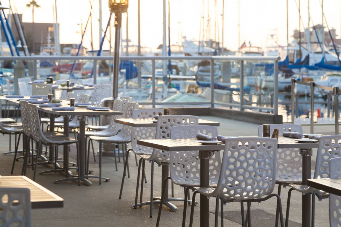 Outdoor dining at Sea Level Restaurant, modern setup for networking events in Redondo Beach.