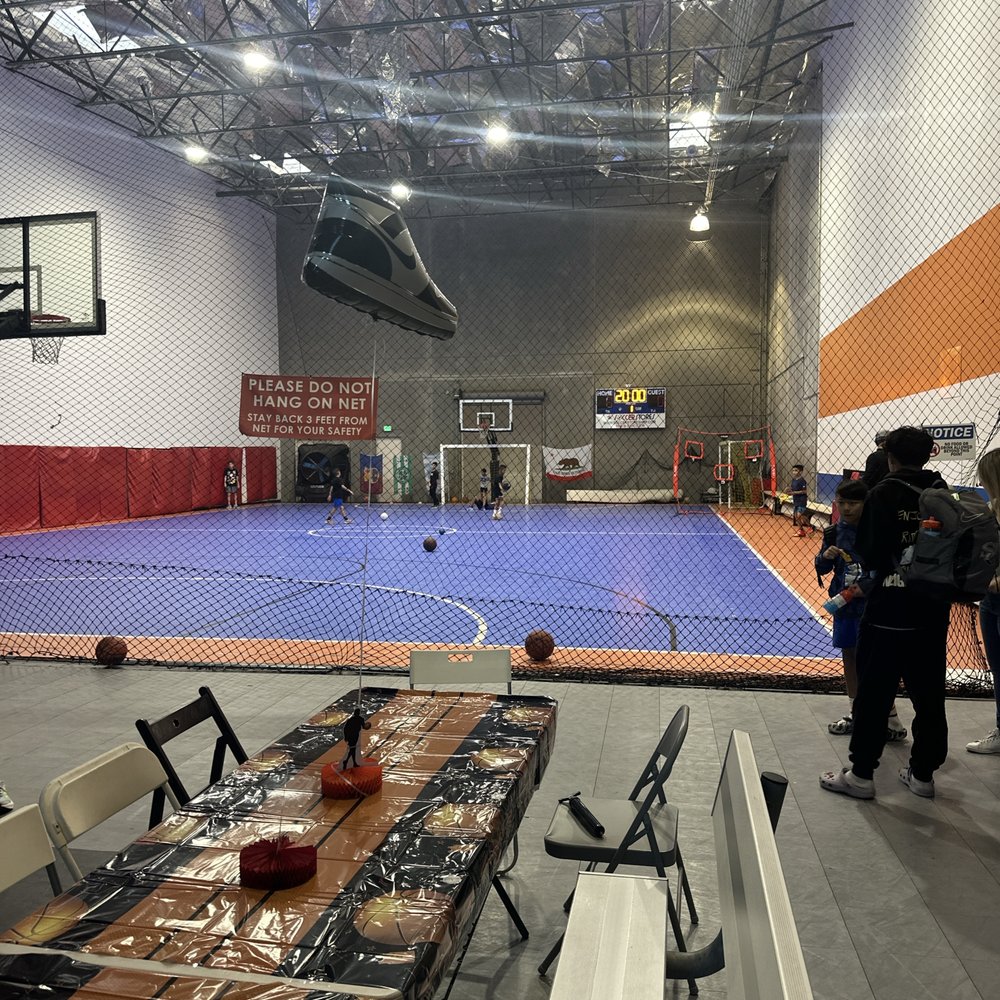 Badminton/Volleyball court with blue flooring for youth sports events in Evolve Project LA.