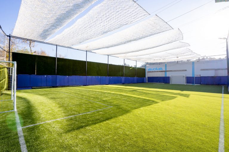 Indoor badminton/volleyball court with turf, perfect for corporate events and fitness activities.