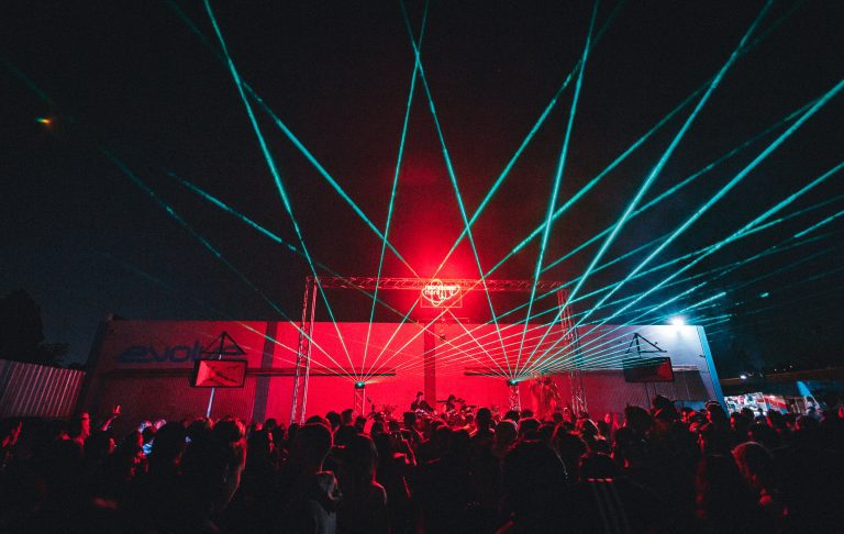 Vibrant lounge area with dynamic laser lights at Evolve Project LA event.